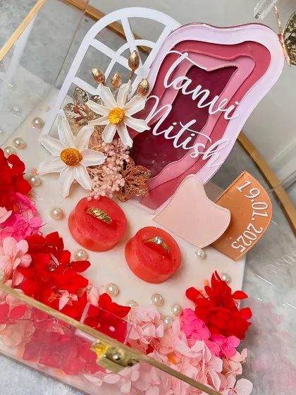 A different angle of the layered ring platter, showing the depth and detail of the custom name sign and floral arrangement.