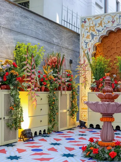 A wider view of the fountain area, showing how lighting was used to highlight the floral arrangements and create a warm ambiance.