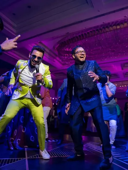 The lead singer of the band gets down on the dance floor with the guests, creating an interactive and high-energy experience for everyone.