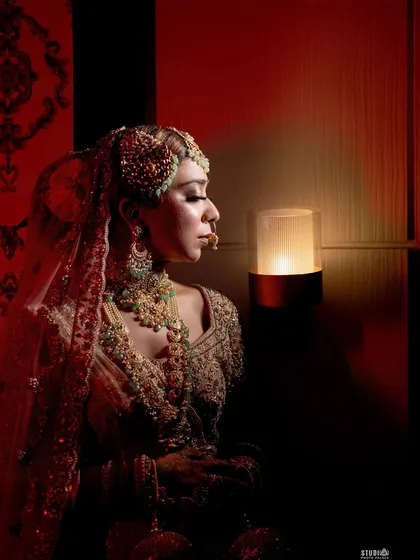 A final, dramatic portrait from my wedding. The side profile against the warm light creates a silhouette effect that emphasizes the hairstyle, jewelry, and the sharp contour of the makeup.
