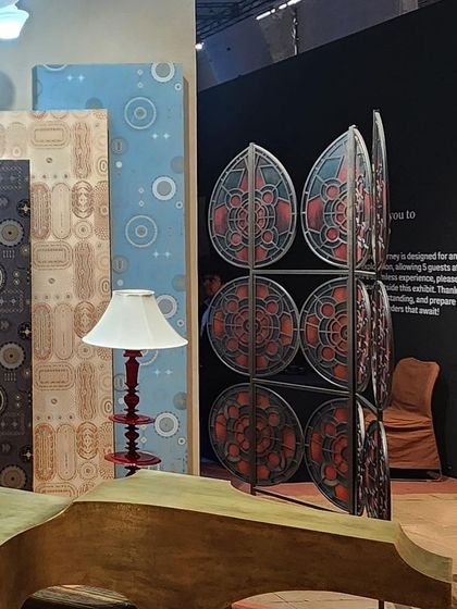 A collection of decor objects from the 'Indofuturism' installation. The space features a mix of wallpapers, furniture, and lighting that all contribute to the surreal and absurdist panorama of the theme.