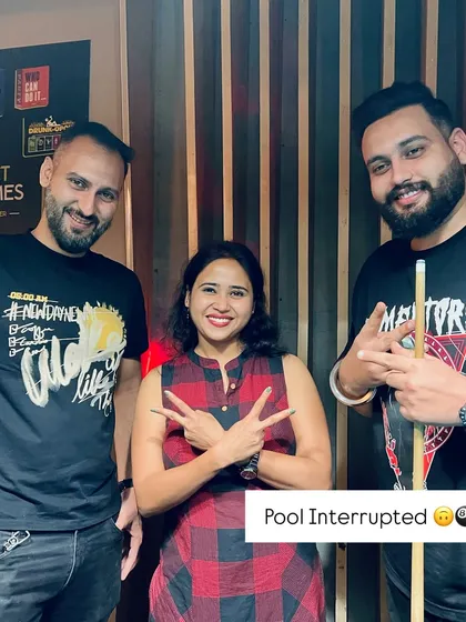 Pool interrupted for a quick photo. Even during a competitive game, there's always time for a smile.