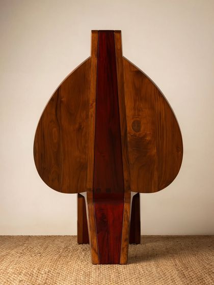 Various angles of the Vismayam chair, showcasing its intricate details, the contrast of different wood grains, and its powerful, sculptural presence. Each view offers a new perspective on this piece of collectible, art-inspired furniture.