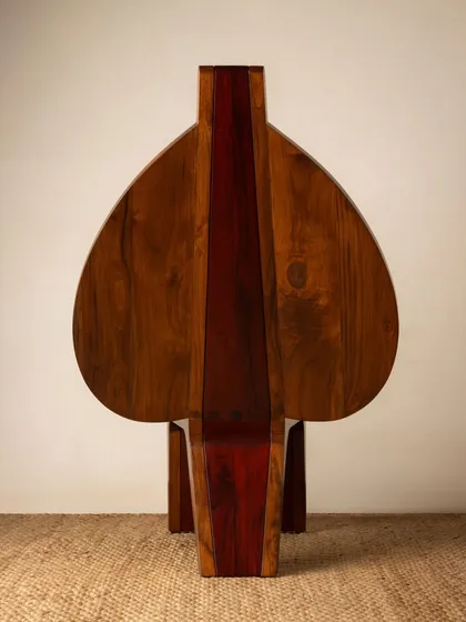 Various angles of the Vismayam chair, showcasing its intricate details, the contrast of different wood grains, and its powerful, sculptural presence. Each view offers a new perspective on this piece of collectible, art-inspired furniture.