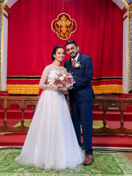 A beautiful portrait of the couple, Rijo and Gigi, inside the church. The bride's simple white gown and the groom's classic blue suit were perfect for the solemn occasion.