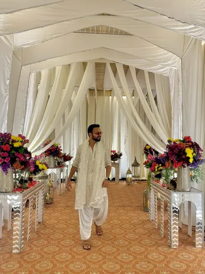 The entrance to a beautiful Sufi Night event. The decor, with its white drapes and floral arrangements, set a serene and elegant mood.