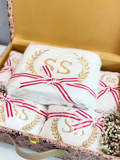 Another view of the monogrammed towels, neatly arranged and tied with red and white striped ribbons.