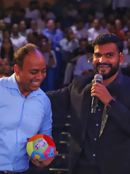 The joy of bringing someone from the audience into the act. His smile shows how much fun it is to be a part of the magic, not just a spectator.