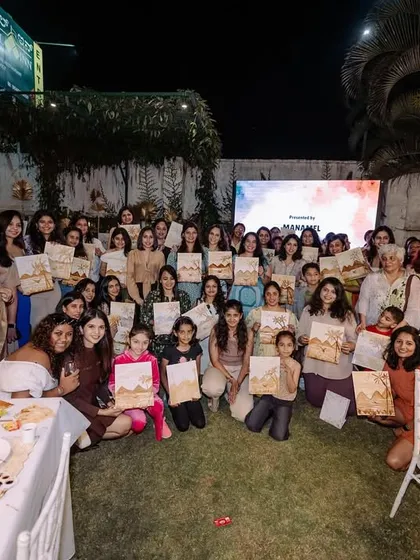 A large group photo from the coffee painting event for Amity Ladies Circle. It was a night of laughter, creativity, and connection.