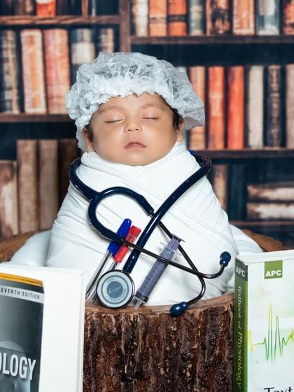 Another take on the future doctor theme, with a focus on the anatomy and embryology books that surround the sleeping baby.