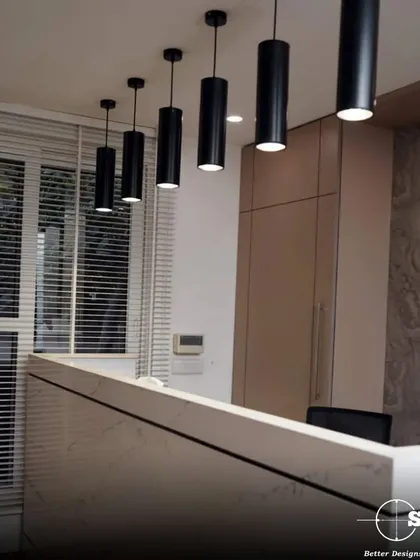 The reception area of a law office, featuring a marble-finish desk and cylindrical pendant lights. The design is clean, modern, and professional, setting a sophisticated tone for visiting clients.