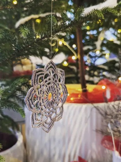 This beautiful, intricate ornament, seen here on one of our Christmas trees, is made from recycled and demonetized currency notes. It's part of our commitment to creating stunning festive decor that is also sustainable and conscious.