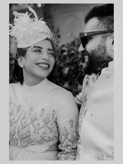 A beautiful black and white portrait of the couple at the polo match, her vintage-style hat adding a touch of classic elegance.
