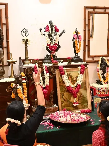 During the Gejjai Puja, we seek blessings from the divine. Here, I am performing the puja with my student before our decorated home altar.