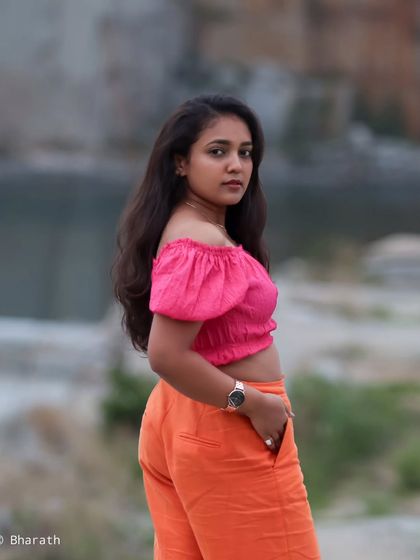 A portrait taken near water, with a soft and slightly blurred background that enhances the calm mood.