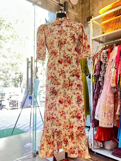 This floral georgette dress is the essence of elegance. With its high neck, tie detail, and ruffled hem, it’s a versatile piece that can be dressed up or down for any occasion.