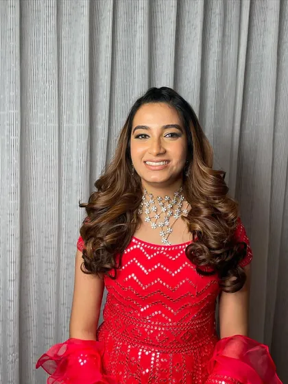This look is all about confidence. The big curls and stunning red dress make for an unforgettable combination.