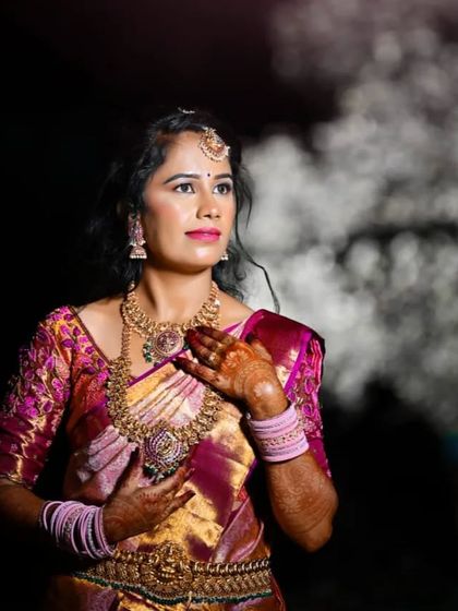 A dramatic shot with a smoky background. The makeup stands out beautifully, with a focus on her expressive eyes and flawless complexion.