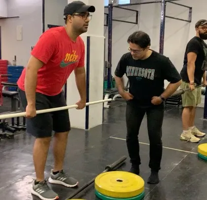 One-on-one feedback is a core part of our seminars. A coach provides personalized cues to an athlete practicing their setup with a PVC pipe.