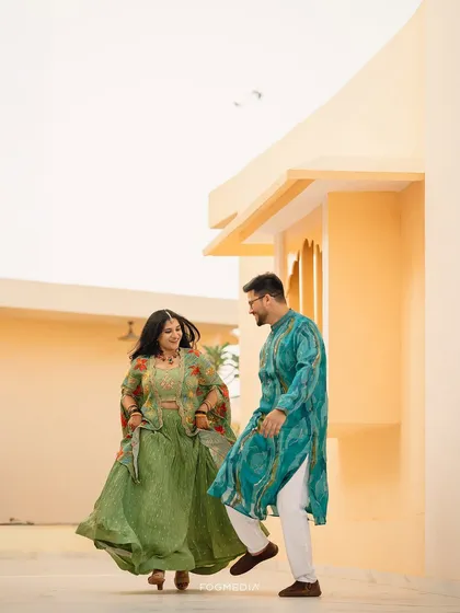 A vibrant and energetic shot from a Haldi ceremony. The colorful outfits and joyful movement perfectly capture the celebratory spirit of the event.