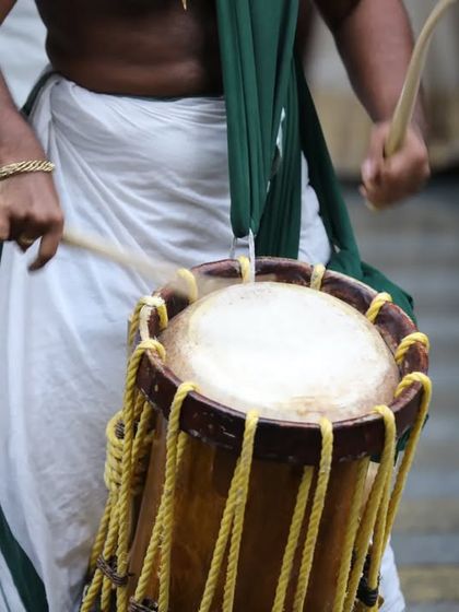 A close-up on the heart of the Melam. This shot shows the technique and force required to play the Chenda, striking the drum to produce its iconic, powerful sound.