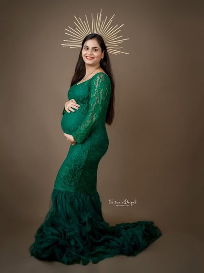 A goddess in green. The golden halo adds a divine touch to this portrait of a mom-to-be in our popular emerald lace gown.