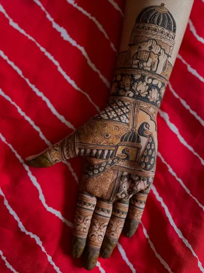 A still image of the Rajasthani-inspired bridal mehendi, showing the rich, dark stain against a vibrant red background.