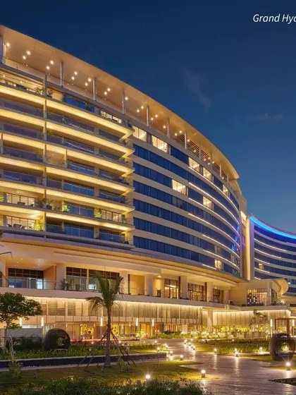 The Grand Hyatt in Kochi, a modern architectural marvel on the waterfront. It's a fantastic choice for a luxurious and contemporary South Indian wedding.