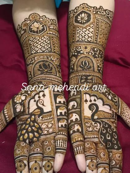 This symmetrical bridal design is packed with traditional motifs, including peacocks, elephants, and lotuses, creating a grand and auspicious look.