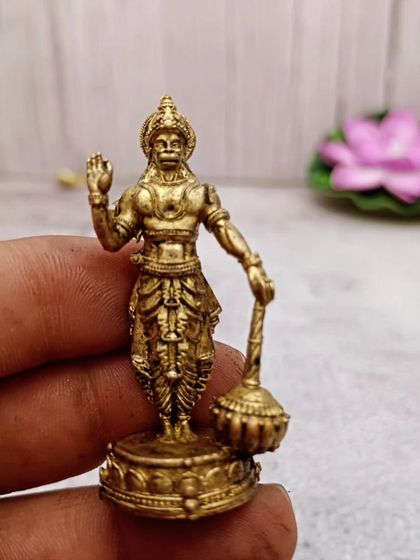 A small, detailed brass idol of Lord Hanuman holding his mace (gada). A symbol of strength, devotion, and protection.