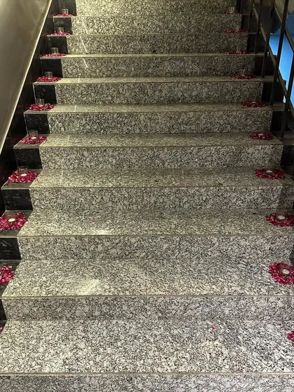 Simple elegance for Diwali. We decorated this staircase with small candles placed inside circles of fresh flower petals, creating a beautiful and fragrant pathway.