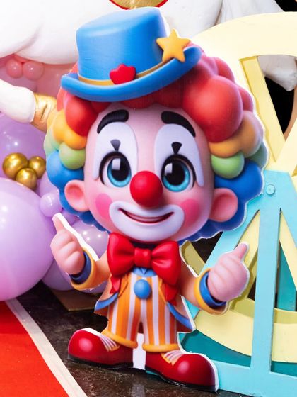 A close-up of a cute and colorful clown cutout used as a decorative element.