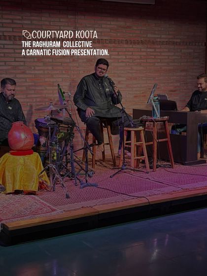 The Raghuram Collective presenting a Carnatic Fusion concert. The artists are seated on stage, creating a modern yet traditional performance atmosphere against our signature exposed brick wall.