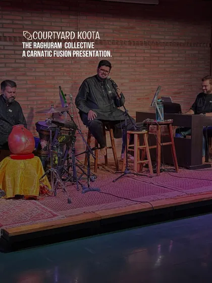 The Raghuram Collective presenting a Carnatic Fusion concert. The artists are seated on stage, creating a modern yet traditional performance atmosphere against our signature exposed brick wall.