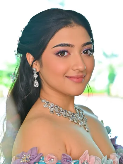 A close-up of the makeup for this enchanting look. The purple eyeshadow is blended softly, and the skin is kept fresh and glowing.