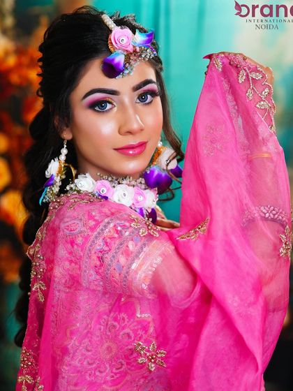 The veil adds a touch of tradition to this modern and colorful Haldi look.