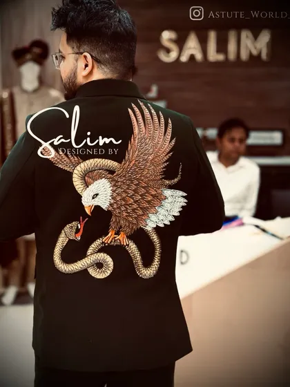 The back of this blazer is a canvas for detailed threadwork, showing an eagle and snake. This is an example of my custom embroidery service, where we can create any powerful animal motif you envision.