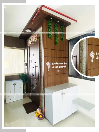 A full view of the entrance area in Majestic Villa, Dronagiri. The design includes a decorative nameplate, a shoe cabinet with a seating bench, and elegant wall paneling with vertical grooves.
