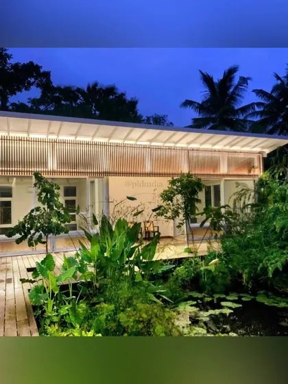 At night, this home by a naturalistic pond glows like a lantern. Our landscape lighting design highlights the beauty of the water lilies and the surrounding plants, creating an enchanting and peaceful evening scene.
