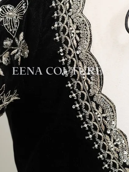 For a chic and contemporary look, I designed this black velvet blouse. It features intricate silver floral embroidery along the scalloped neckline and sleeves, creating a stunning contrast that is perfect for any special occasion.