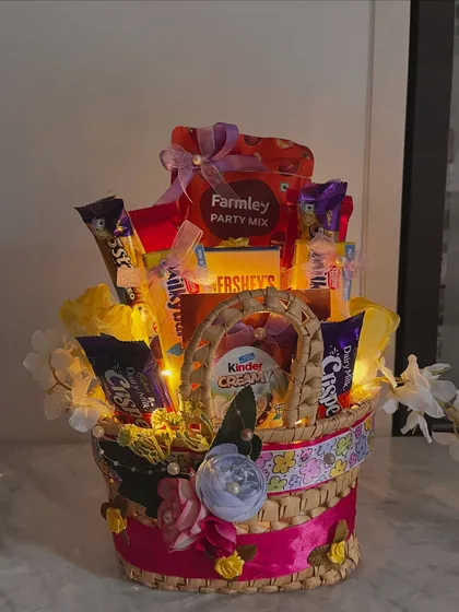 The final, picture perfect shot of the yellow chocolate and snack basket, ready to make someone's birthday a whole lot sweeter.