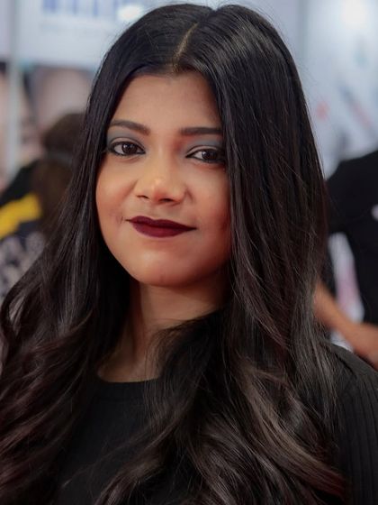 A portrait of a model after our live demonstration, showcasing a modern, layered haircut. We teach styles that are both creative and commercially popular.