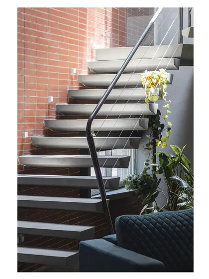 We believe details define the design. This floating staircase, carved from concrete, is a study in minimalism and structural engineering. Each step is a wedge-like form, creating a sense of lightness and motion that transforms a functional element into a sculptural centerpiece.