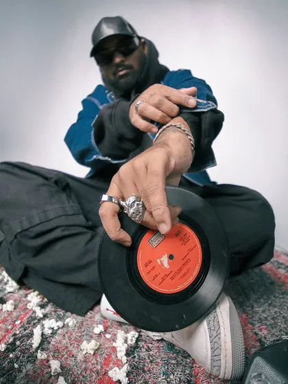 A close-up shot offering a vinyl record. This symbolizes my role as a curator, sharing the music I love with the world.