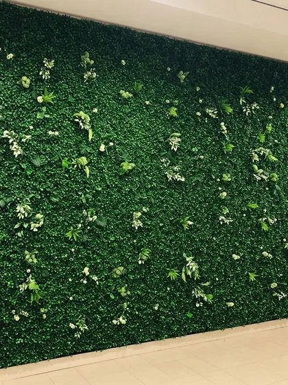A simple yet elegant artificial boxwood hedge wall. This type of green wall is perfect for creating a clean, uniform backdrop for events, logos, or as a privacy screen.