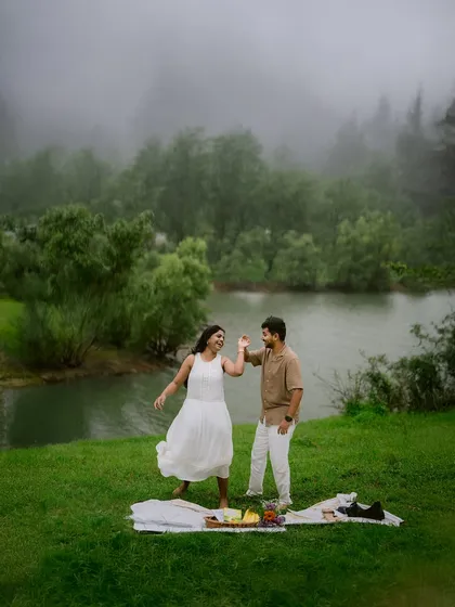 A moment of pure, carefree joy. This couple's playful dance during their lakeside picnic captures the fun and spontaneity I love to see in a pre-wedding session.