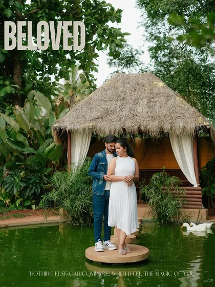 A romantic portrait at a beautiful resort. The couple stands on a small island in a pond, surrounded by lush greenery and swans, creating a fairytale-like setting for their pre-wedding shoot.