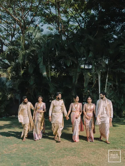 A beautiful portrait of the couple with their family, walking together in their coordinated traditional outfits. This shot celebrates the union of two families.