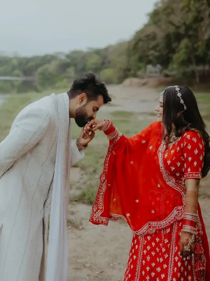 A classic romantic gesture, with the groom kissing the bride's hand during their pre-wedding photoshoot.