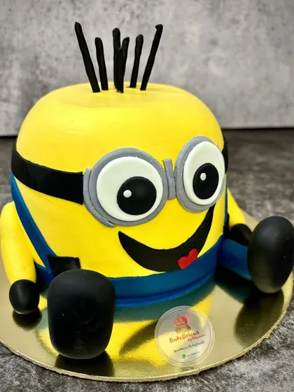 Bello! This fun 3D Minion cake is sure to bring a smile to anyone's face. I shaped this cake and decorated it with his signature goggles and cheeky grin.